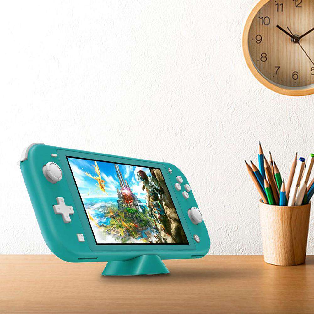 The Switch is connected to the charging dock and placed on the tabletop.